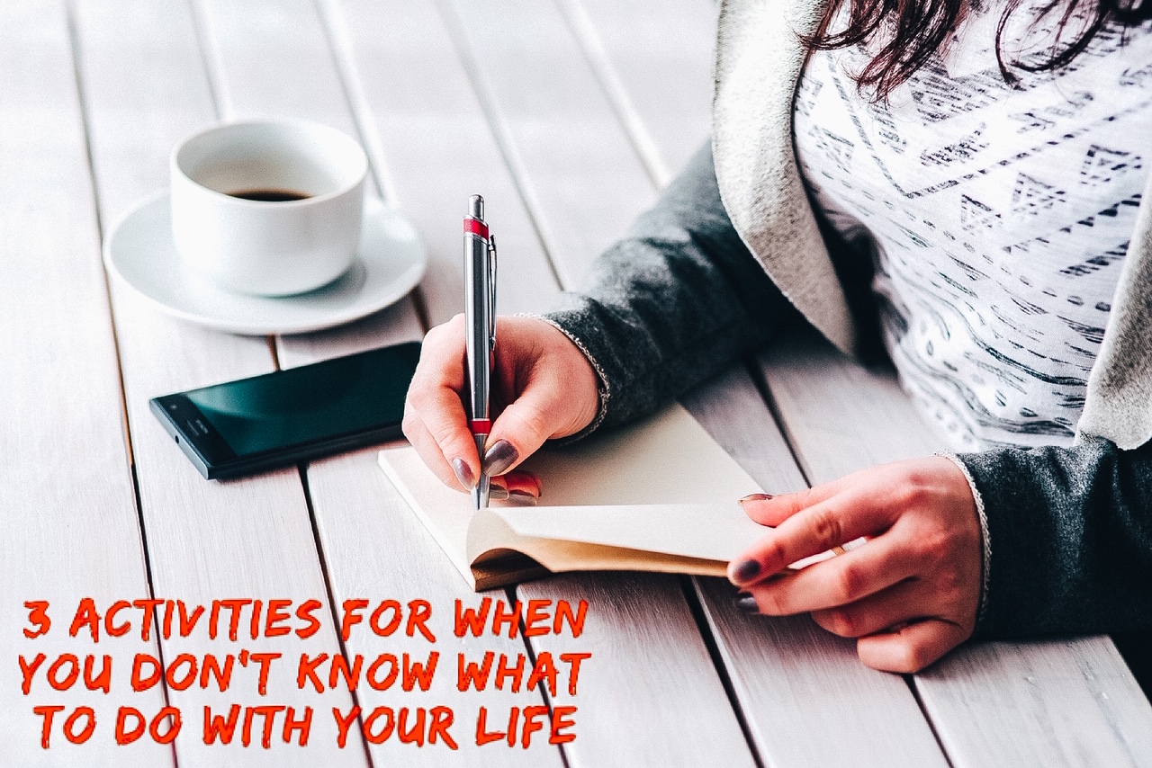 A woman sitting at a table, writing in a notebook with a cup of coffee next to her